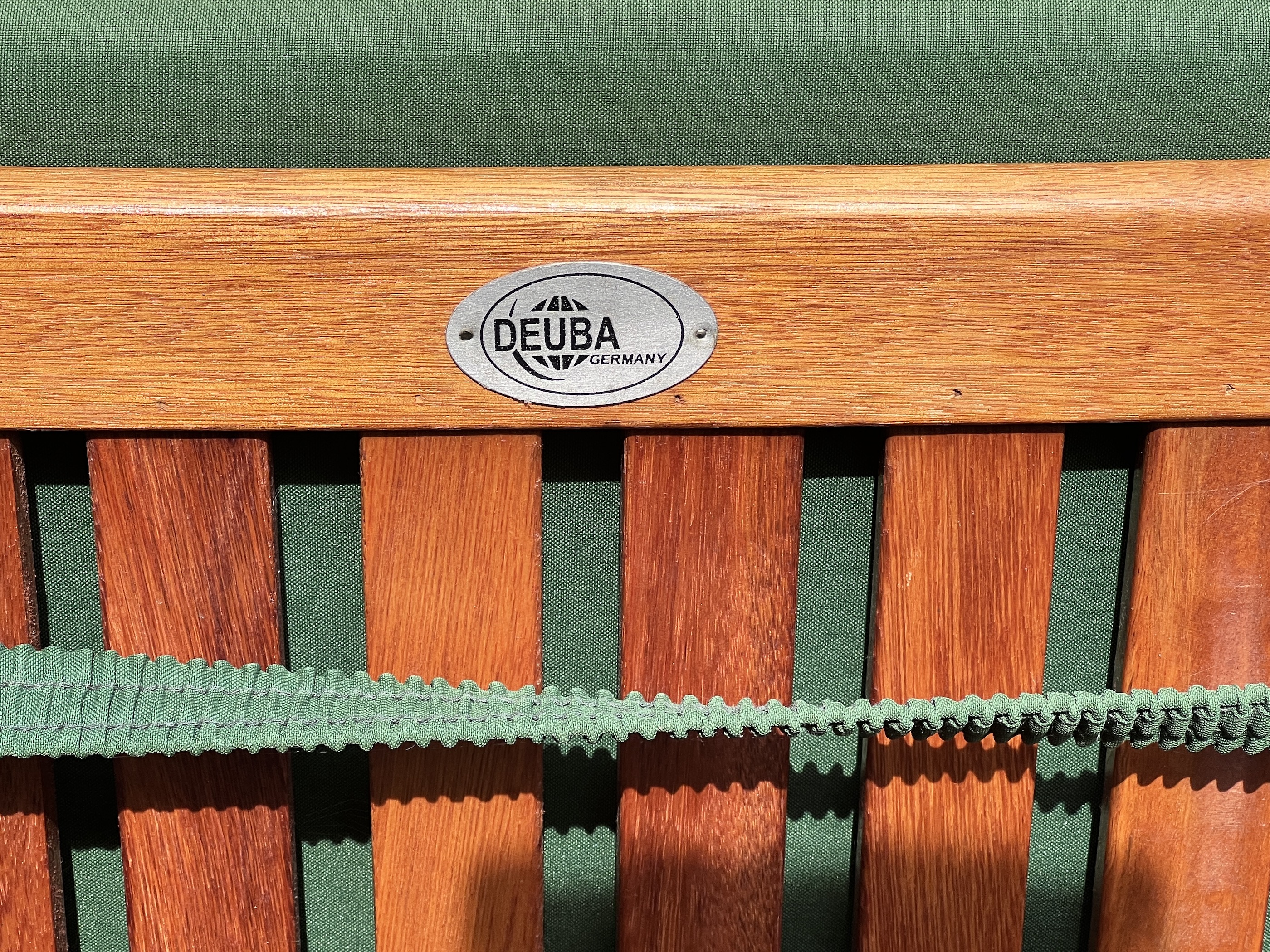 A stained teak extending garden table, length 150cm, depth 100cm, height 76cm, together with six Deuba teak folding garden chairs with cushions